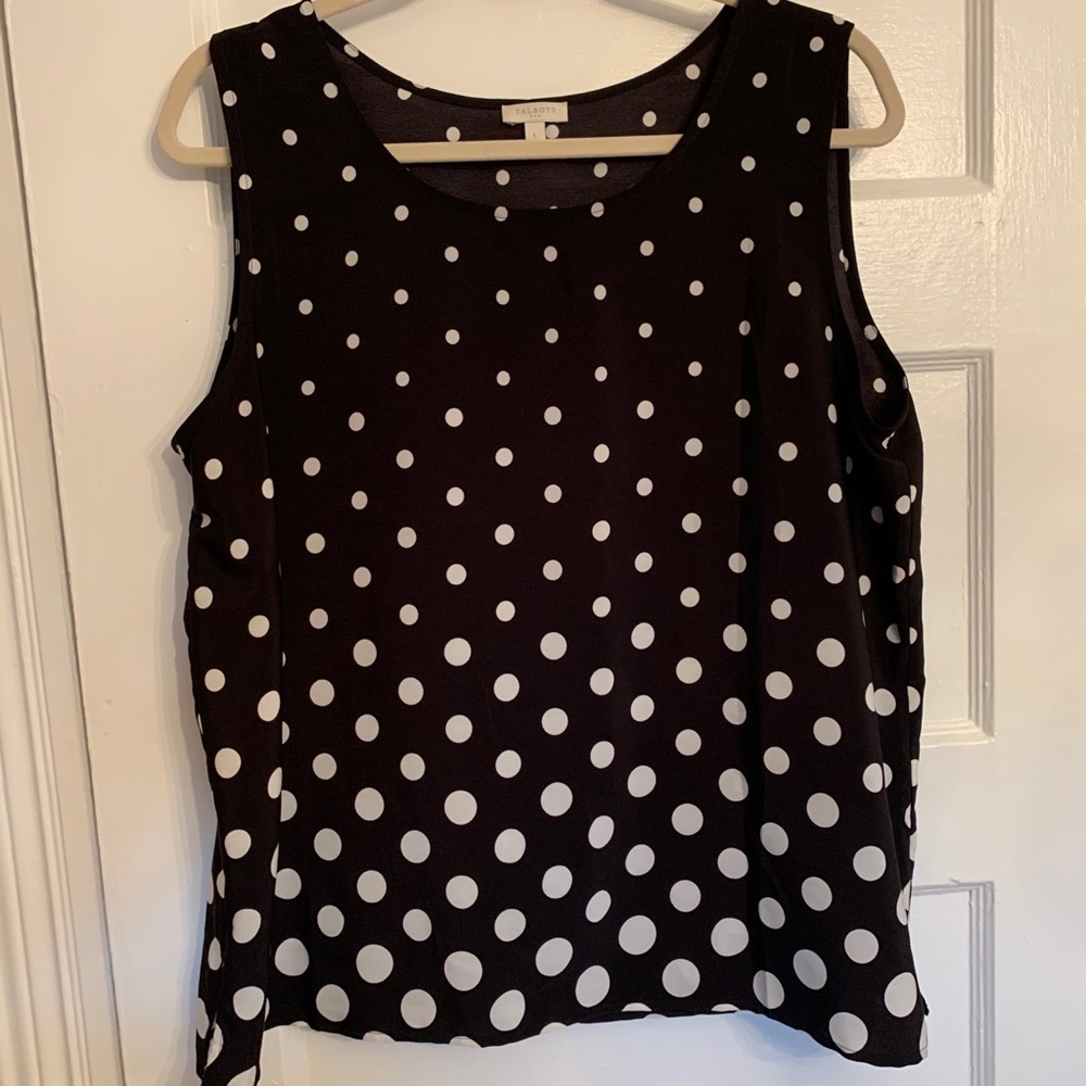 Sleeveless black and white polka dot blouse